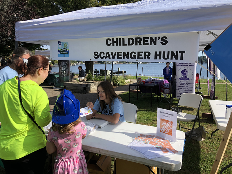 A child stands in front of a booth at the 2021 Lake Hopatcong Block Party