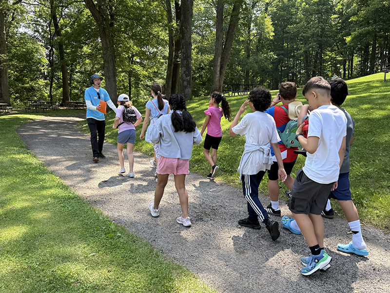Patrick Krudop takes a group of students on a hike as part of the field trip program.