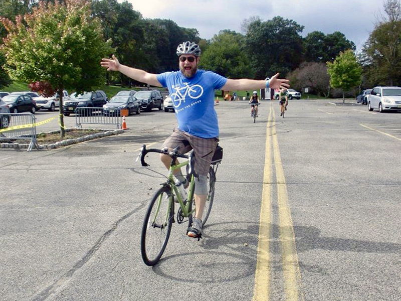 Happy biker with arms out