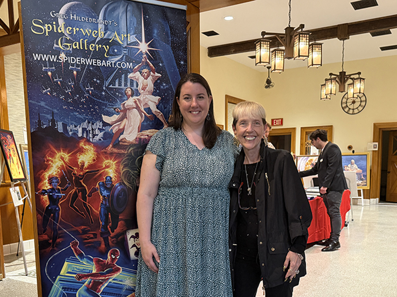 Jean Scrocco and Caitlin Doran pose for a photo outside of the Greg Hildebrandt art show