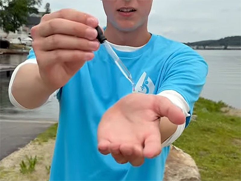 Patrick Krudop holds an eyedrop with water in it