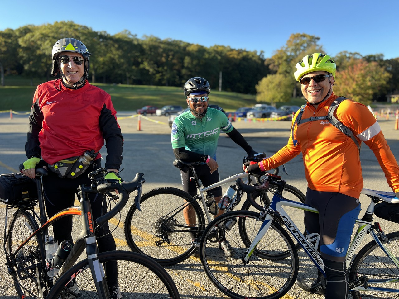 Bikers stand next to their bicycles at the 2024 Lake Loop