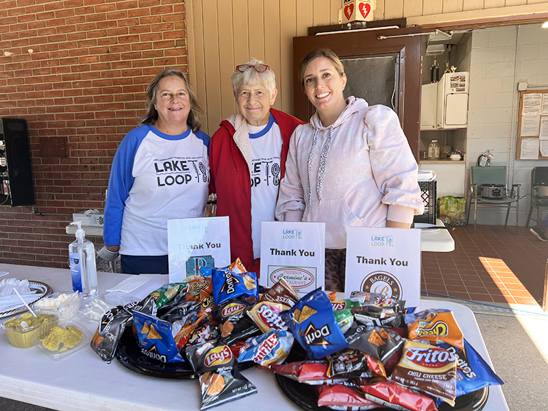 Volunteers smile at the 2024 Lake Loop