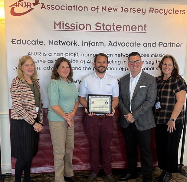 A group poses with an award