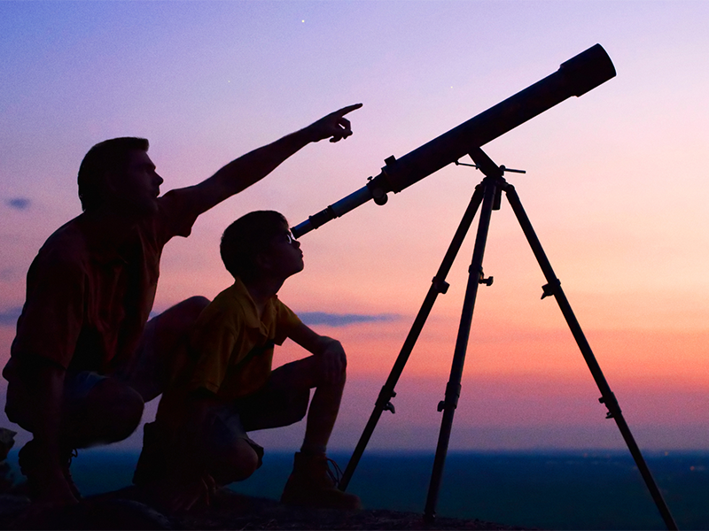 People surround a telescope