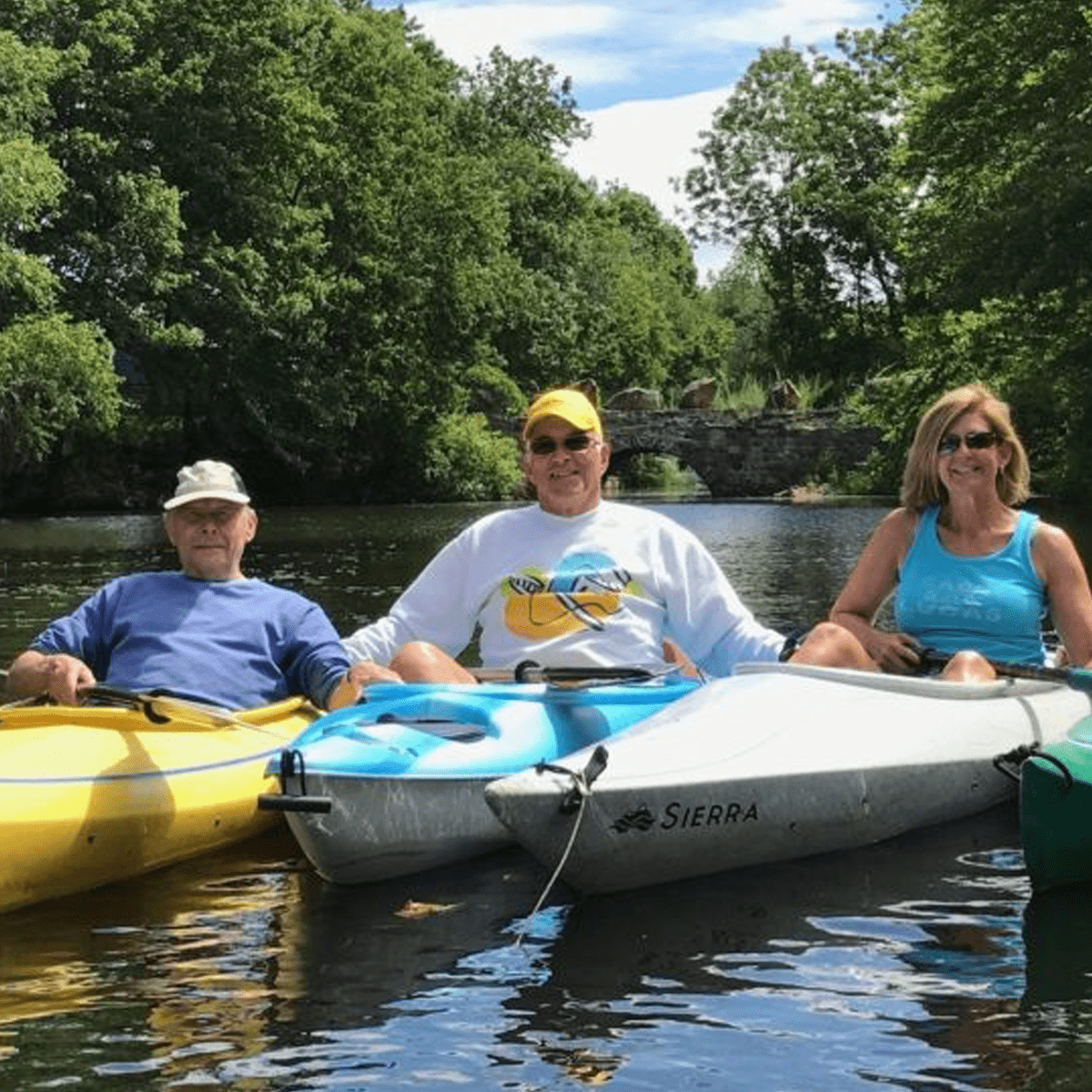 group of kayakers smiling for a picture as they float down Lake Hopatcong